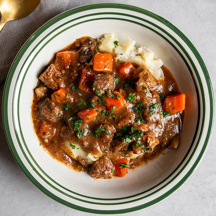 Sous vide beef bourguignon with slow-cooked beef, red wine sauce, bacon, mushrooms, and herbs.