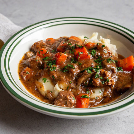 Sous vide beef bourguignon with slow-cooked beef, red wine sauce, bacon, mushrooms, and herbs.