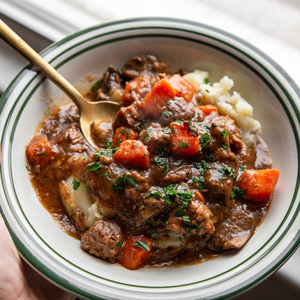 Sous vide beef bourguignon with slow-cooked beef, red wine sauce, bacon, mushrooms, and herbs.