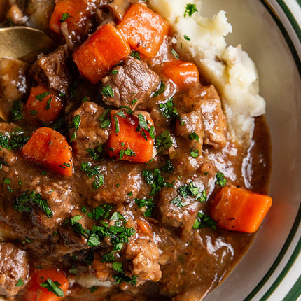 Sous vide beef bourguignon with slow-cooked beef, red wine sauce, bacon, mushrooms, and herbs.
